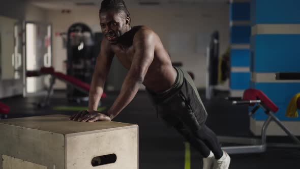 Strong Handsome African American Man Doing Pushups on Gym Cube Wide Shot