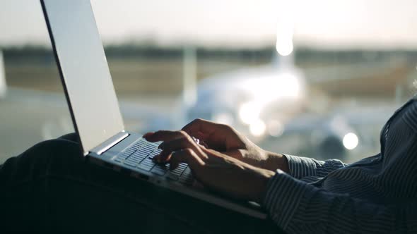 Close Up of a Laptop Being Typed on By a Lady at the Airport