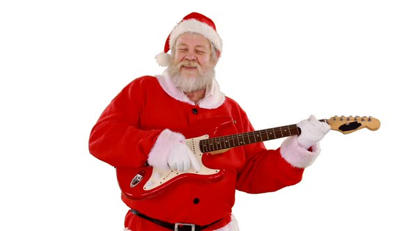 Santa claus singing a song and playing guitar