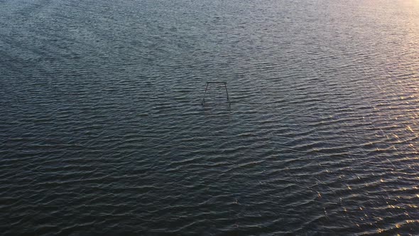 Picturesque summertime view of Salton rippling water sea with abandoned childhood wooden swing set i