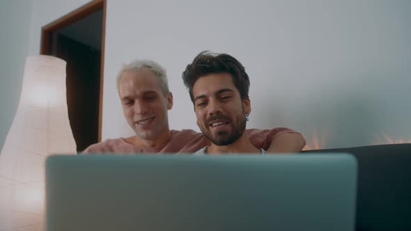 Handsome Gay Couple Making an Online Video Call with Friends or Family