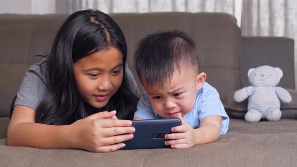 Little Boy Crying And Take Smartphone From His Sister