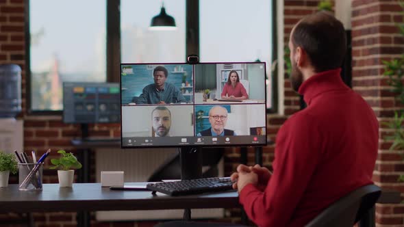 Businessman Talking to Colleagues on Remote Videoconference