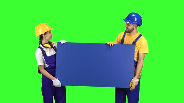 Builders of the Guy with the Girl Touting the Product and Show Their Thumbs Up. Green Screen