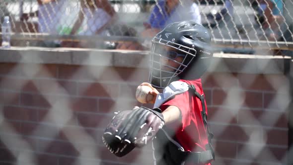 Close-up of a boy playing catcher for a little league baseball team.