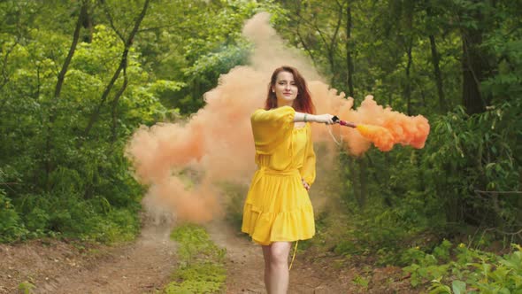 Smiling Woman Walking with Smoke Bomb in Forest