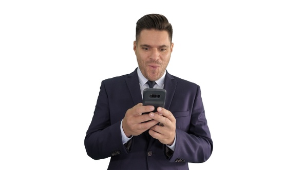 Businessman looking at smartphone with surprise expression