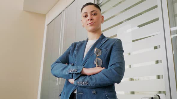 Ambitious young businesswoman in office, looking at camera