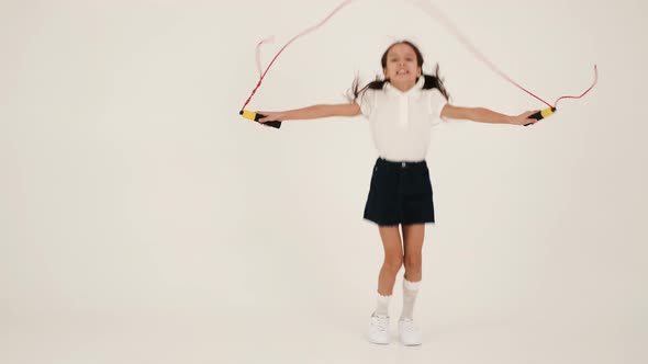 Little Girl Skipping with Rope in Studio