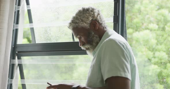 Video of african american senior man using smartphone