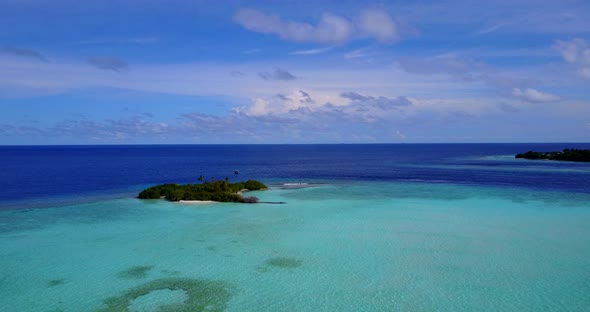 Daytime aerial travel shot of a summer white paradise sand beach and blue ocean background in hi res
