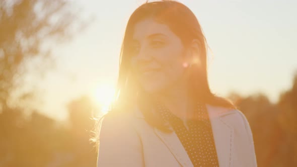 Young beautiful girl at sunset in the countryside