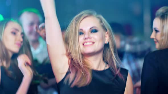 Beautiful Blond Woman is Dancing at a Party