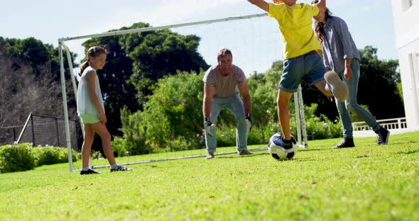 Happy family playing football