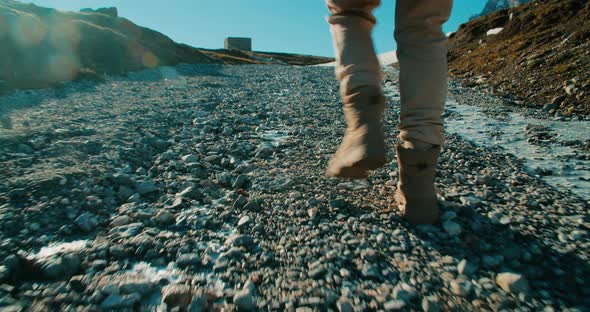 Low Angle Camera Follow Footsteps of Hike Woman on Mountain Journey at Sunset