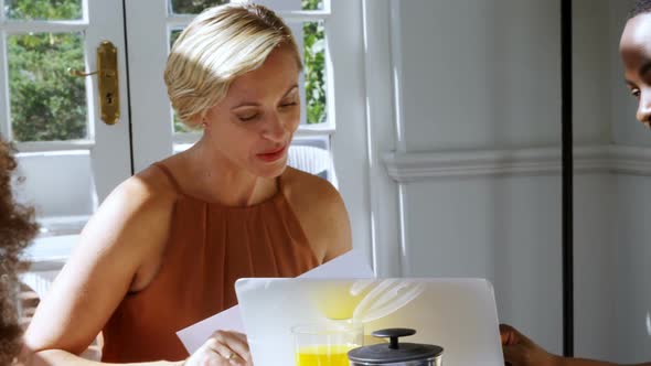 Executive discussing over laptop in restaurant