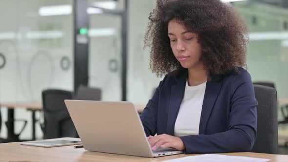 Serious African Businesswoman with Laptop Shaking Head in Denial No