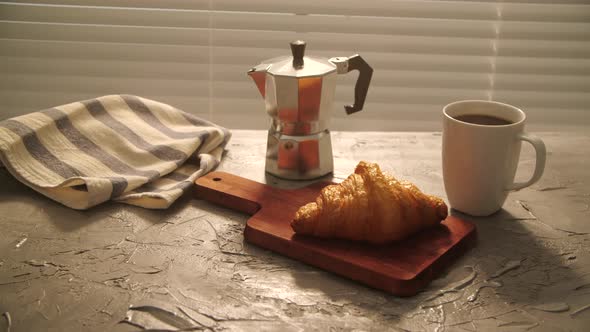 Food and Drinl Concept. Morning Breakfast - Coffee and Croissant on a Table