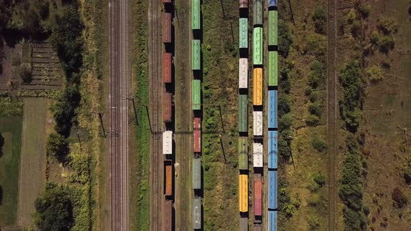 Flying Above Industrial Railroad Station with Cargo Trains