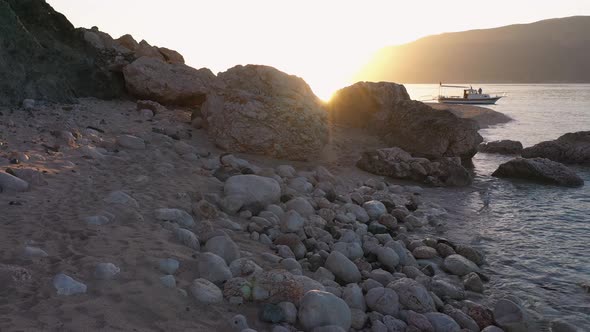 Sunset Over Sandy Beach with Rocks