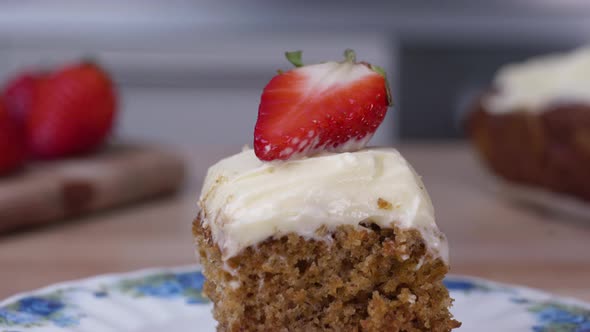 Delicious carrot cake topped with a strawberry slice - close up