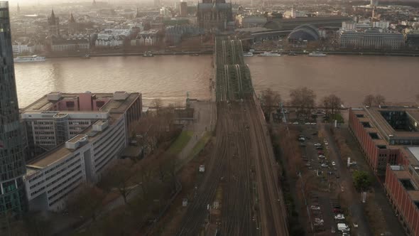 AERIAL: View Over Cologne Hohenzollern Bridge and Cathedral in Beautiful Hazy Sunlight 