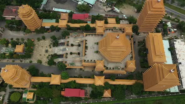 Top down drone shot flying in over a large Buddhist Temple or Pagoda in Ho Chi Minh City, Vietnam