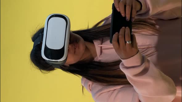 Multiracial Girl in Virtual Reality Glasses Playing Online Games on Smartphone