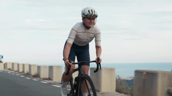 Strong Woman Pro Cyclist on Mountain Top Road