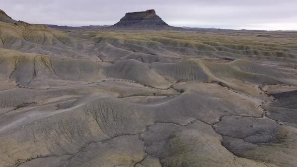 Flying towards Factory Butte over dunes