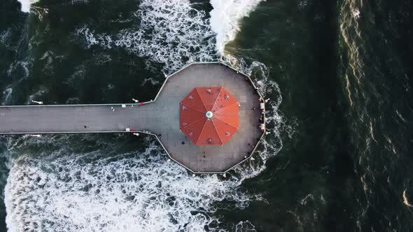 Top down aerial view of the Roundhouse Aquarium and Manhattan Beach Pier in the ocean