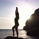 Young Woman with Long Hair Practicing Stretching Outdoors on Yoga Mat By the Sea on a Warm Sunset - VideoHive Item for Sale