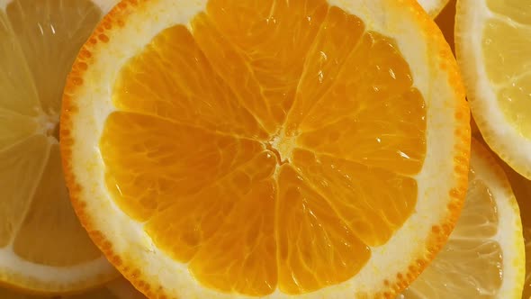 Lemon Slices with One Cut Orange Slice Closeup Summer Background Top View