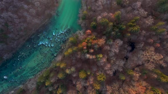 Flying over the river and hills at sunrise