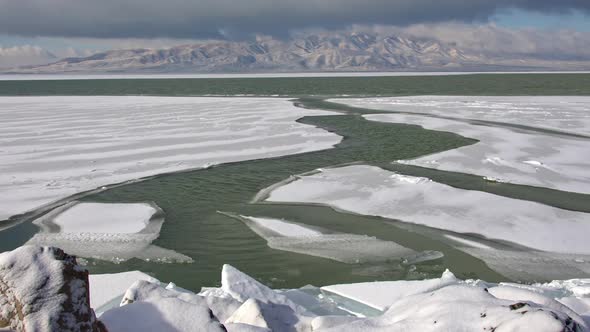 Cracks on the surface of frozen Utah Lake shifting on the surface