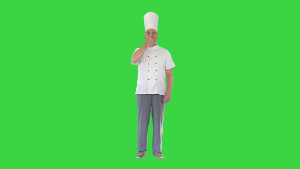 Professional Chef Man Showing Sign for Delicious on a Green Screen Chroma Key