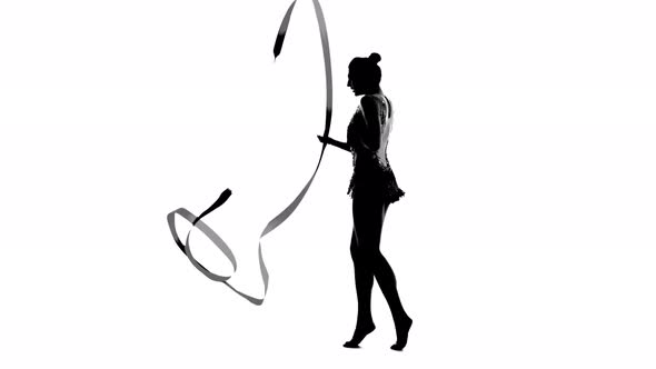 Gymnast in a Nice Suit Creates a Ribbon of Different Waves. White Background. Silhouette