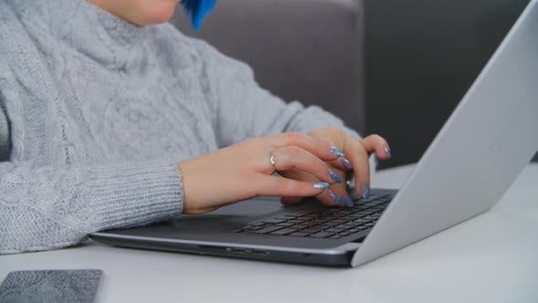 Woman working on laptop computer at home in closeup 4k stock video clip