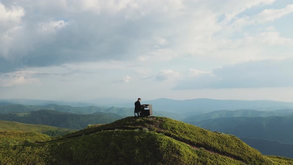 Aerial View of Man Two Hands Plays Gentle Classical Music on a Grand Piano on Nature