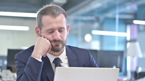 Portrait of Businessman Having Quick Nap in Office