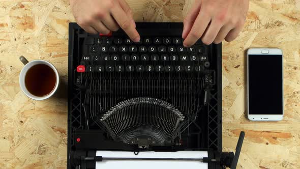 Male Hands Typing on the Typewriter. View From Above