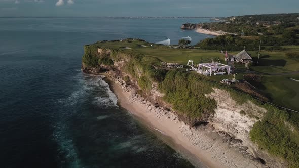 Aerial Footage of the Beach and a Big Cliff with a Wedding on Top of It