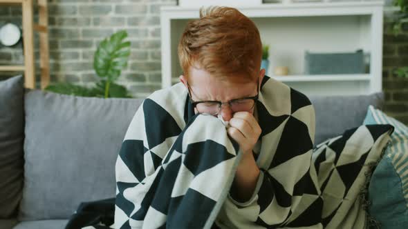 Unwell Man Taking Paper Tissue and Sneezing Feeling Bad at Home Alone