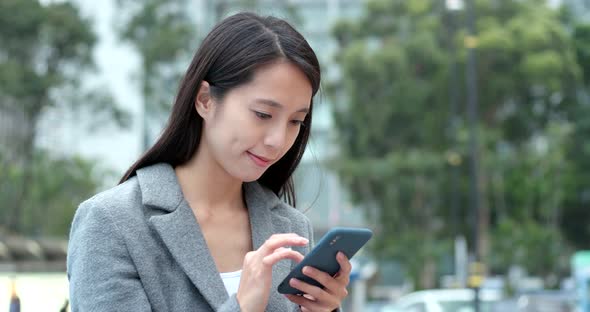 Asian Woman use of cellphone in city