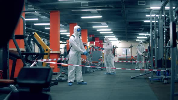 Group of Disinfectors Are Sanitizing Fitness Center
