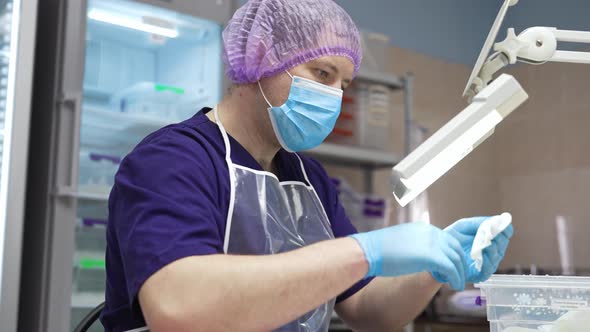 A Laboratory Worker Checks the Condition of the Samples Before Testing