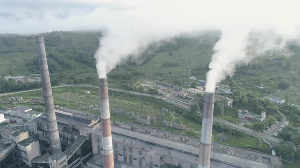 Aerial Drone View of Smoking Pipes and Cooling Towers of Coal Thermal Power Plant