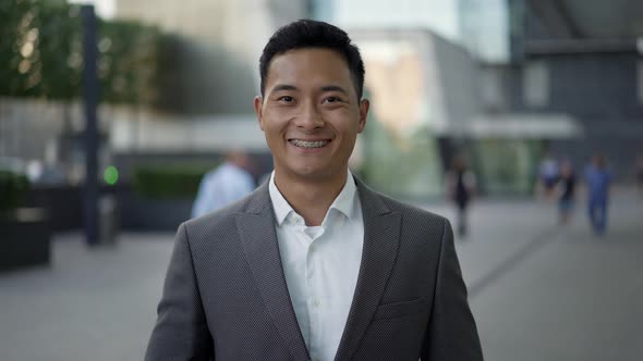 Real Time Portrait Shot of a Young Happy Asian Businessman Smiling