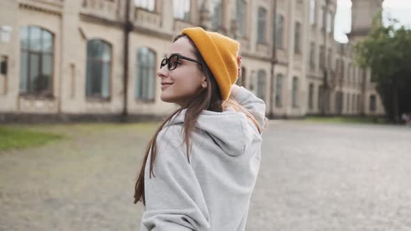 Portrait of a Young Woman in a Yellow Hat with a Good Mood