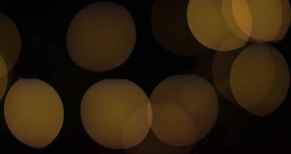 Seamless Looped Bokeh Effect Animation, Abstract gold light bokeh isolated on black background